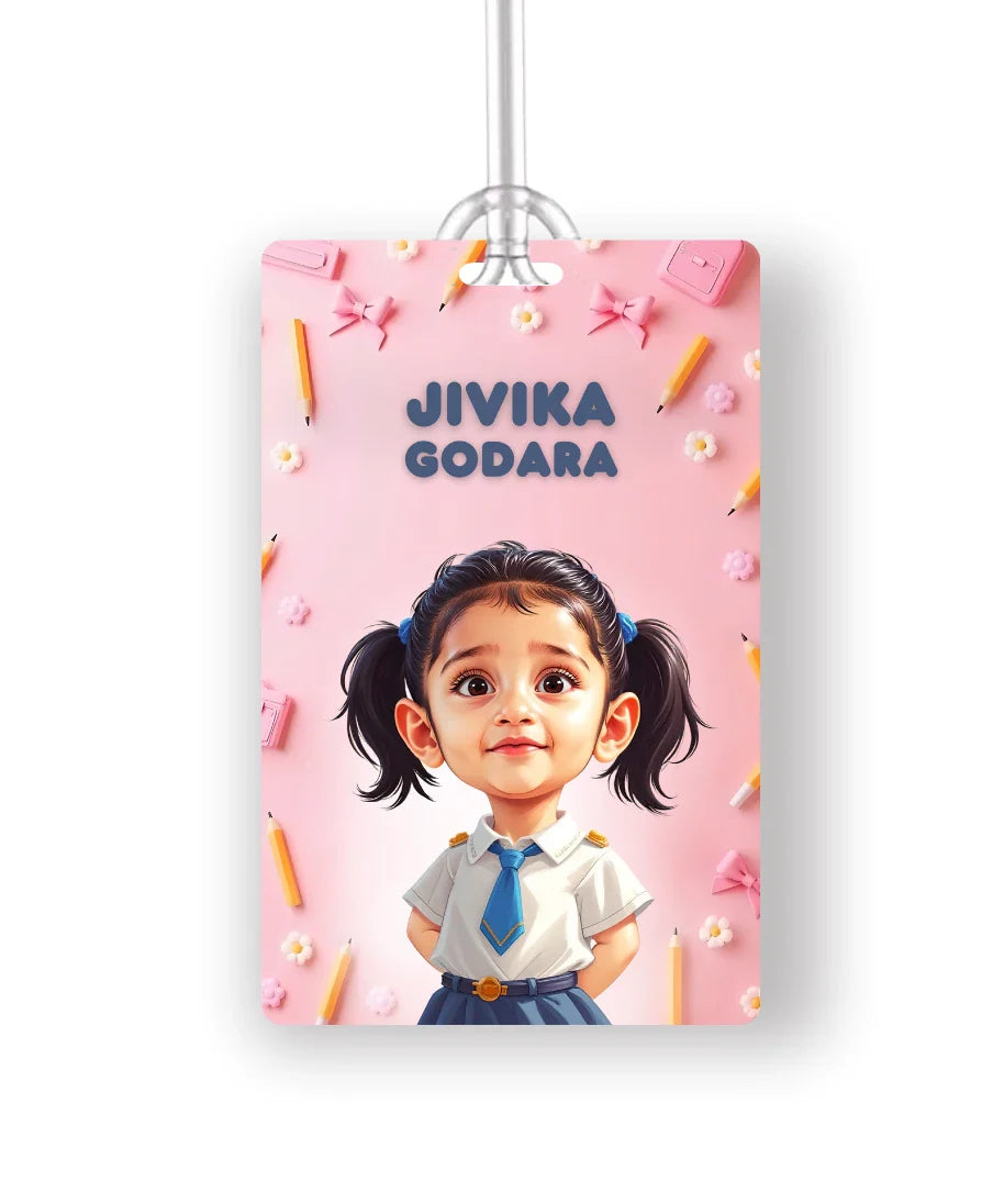 Personalised school bag tag with cartoon photo of a girl in school uniform and name Jivika Godara on pink background